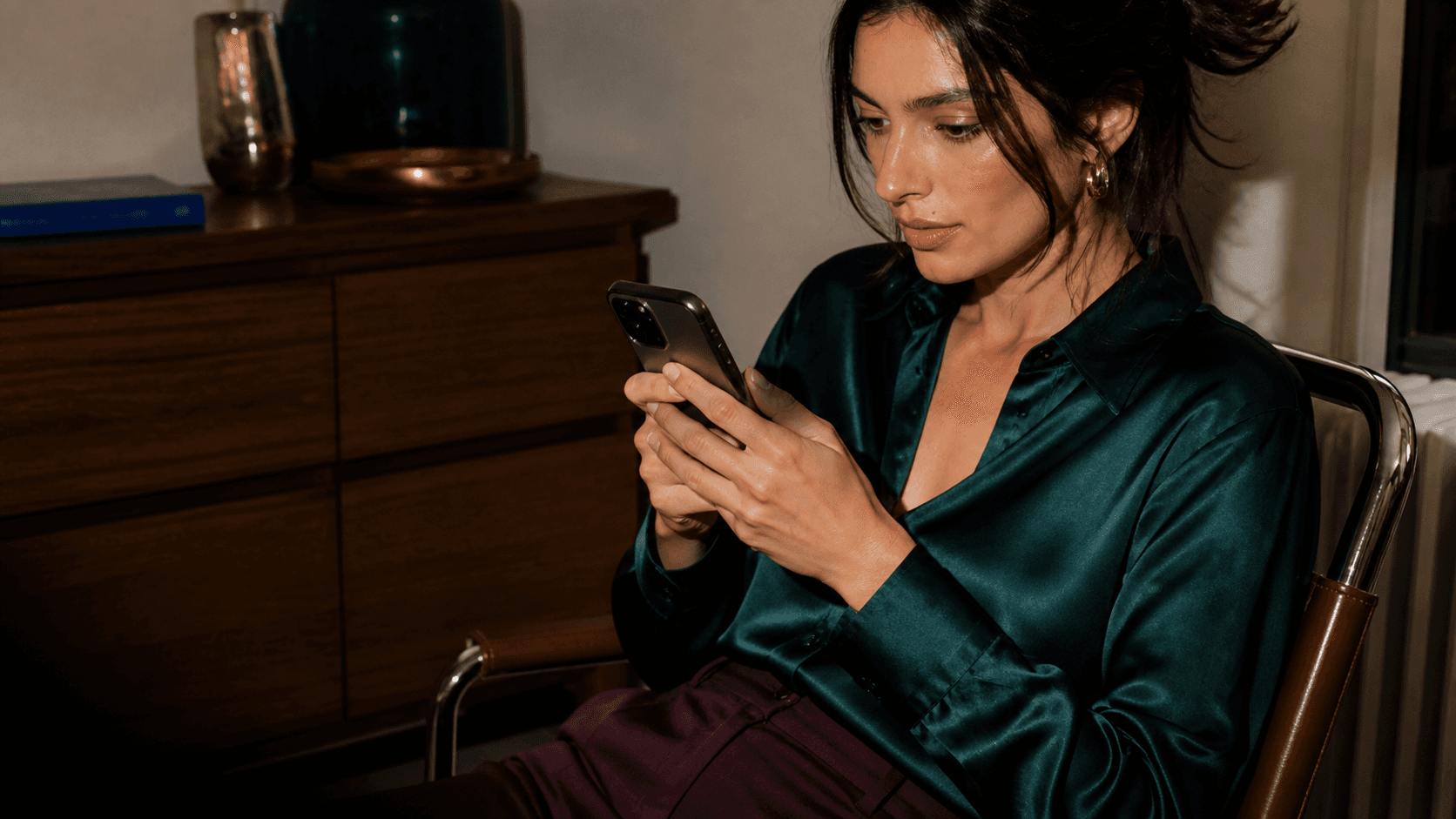 A woman shopping on her phone at home.